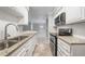 Modern kitchen featuring granite countertops, stainless steel appliances, and white subway tile backsplash at 23307 Plantation Ne Dr, Atlanta, GA 30324