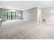 Bright living room with neutral carpet, grey paint, large arched window, and white trim at 23307 Plantation Ne Dr, Atlanta, GA 30324