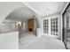 Open living space with stone fireplace and arched entryway leading to kitchen and french doors leading to balcony at 23307 Plantation Ne Dr, Atlanta, GA 30324