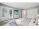 Serene main bedroom with white french doors, a dresser, and closet space, creating a peaceful retreat at 23307 Plantation Ne Dr, Atlanta, GA 30324