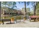 Picturesque view of a community pond with fountain, benches and well maintained landscaping at 23307 Plantation Ne Dr, Atlanta, GA 30324