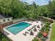 Aerial view of a pristine community pool with lounge chairs and seating areas, surrounded by lush landscaping at 23307 Plantation Ne Dr, Atlanta, GA 30324