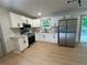 Modern kitchen with stainless steel appliances, white cabinets, and light wood-look floors at 4396 Greenleaf Cir, Atlanta, GA 30331