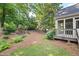 A peaceful backyard showcasing a well-maintained landscape and a cozy screened-in porch at 795 Lake Medlock Dr, Alpharetta, GA 30022
