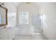 Clean bathroom with a soaking tub, glass shower, and vanity with ample counter space at 795 Lake Medlock Dr, Alpharetta, GA 30022