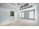 Primary bedroom featuring tray ceiling, neutral color palette, and ample natural light at 795 Lake Medlock Dr, Alpharetta, GA 30022