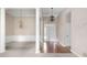 Elegant foyer with gleaming hardwood floors, chandelier, and white trim at 795 Lake Medlock Dr, Alpharetta, GA 30022