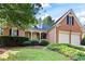 Beautiful brick home with a well-maintained lawn and garden, complemented by an attached two-car garage at 795 Lake Medlock Dr, Alpharetta, GA 30022