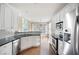 Bright kitchen boasts white cabinets, stainless steel appliances, black counters, and an eat-in breakfast area at 795 Lake Medlock Dr, Alpharetta, GA 30022