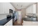 Eat-in kitchen featuring granite counters, stainless steel appliances, white cabinets, and modern lighting at 795 Lake Medlock Dr, Alpharetta, GA 30022
