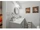 Stylish bathroom features a white vanity with decorative mirror and modern fixtures at 2900 Townley Cir, Atlanta, GA 30340