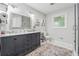 Bathroom featuring a double vanity, decorative mirror, and tile flooring at 2900 Townley Cir, Atlanta, GA 30340