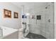 Modern bathroom features a glass-enclosed shower with stone-look tile, a built-in bench, and black tile flooring at 2900 Townley Cir, Atlanta, GA 30340