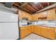 Basement kitchen features wooden cabinets, white appliances, and a sink with laminate countertops at 2900 Townley Cir, Atlanta, GA 30340