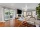 Cozy living room with brick fireplace, hardwood flooring, and access to outdoor patio at 2900 Townley Cir, Atlanta, GA 30340