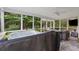 Relaxing screened-in porch featuring a hot tub, seating area, and wooded views at 2900 Townley Cir, Atlanta, GA 30340