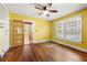 Bedroom featuring hardwood floors, natural light, and bright yellow walls at 3956 Tell Sw Rd, Atlanta, GA 30331