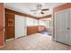 Dining room featuring a ceiling fan, tile floors, wood paneling, and access to sunroom at 3956 Tell Sw Rd, Atlanta, GA 30331