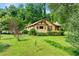 Exterior shot of a charming one-story home with a well-manicured lawn and mature landscaping at 3956 Tell Sw Rd, Atlanta, GA 30331