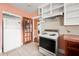 Eat-in kitchen featuring tile floors, white cabinets, white appliances, and tile backsplash at 3956 Tell Sw Rd, Atlanta, GA 30331
