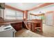 Eat-in kitchen featuring tile countertops, tiled backsplash, wood cabinets, and white appliances at 3956 Tell Sw Rd, Atlanta, GA 30331