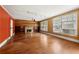 Spacious living room with hardwood floors, stone fireplace, built-in bookshelves, and natural light at 3956 Tell Sw Rd, Atlanta, GA 30331