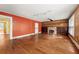 Living room featuring a fireplace, built-in bookshelves, hardwood floors, and natural light at 3956 Tell Sw Rd, Atlanta, GA 30331