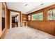 Inviting sunroom with built-in shelves, tile flooring, and natural light from many windows at 3956 Tell Sw Rd, Atlanta, GA 30331
