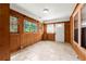 Bright sunroom featuring tile flooring, natural light from multiple windows, and wood paneling at 3956 Tell Sw Rd, Atlanta, GA 30331