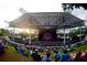 Vibrant outdoor amphitheater filled with people enjoying a performance, showcasing a lively entertainment venue at 420 Banbury Xing, Alpharetta, GA 30009