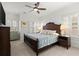Bedroom with wooden bed frame, bedside table, and shuttered windows at 420 Banbury Xing, Alpharetta, GA 30009