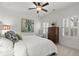 Bright bedroom featuring plush bedding, ceiling fan, crown molding, and shuttered windows at 420 Banbury Xing, Alpharetta, GA 30009