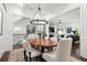 Spacious dining room featuring decorative rug, trim work, hardwood flooring and adjacent living area at 420 Banbury Xing, Alpharetta, GA 30009