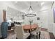 Bright dining room boasts decorative chandelier, detailed trim work, and hardwood flooring at 420 Banbury Xing, Alpharetta, GA 30009