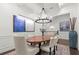 Dining room with a decorative chandelier, coffered ceiling, and view of the upstairs landing at 420 Banbury Xing, Alpharetta, GA 30009