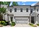 Attractive two-story home with a two-car garage and a front door and a well-manicured lawn at 420 Banbury Xing, Alpharetta, GA 30009