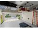 Spacious garage featuring overhead storage racks and an epoxy floor for functionality and organization at 420 Banbury Xing, Alpharetta, GA 30009
