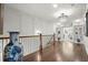 Hallway with hardwood floors, decorative vase, chandelier and views to other rooms at 420 Banbury Xing, Alpharetta, GA 30009