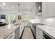 Bright modern kitchen with stainless appliances, large island, and a door leading to an outdoor space at 420 Banbury Xing, Alpharetta, GA 30009