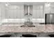 Close-up of a kitchen island with granite countertops, stainless steel sink, and modern fixtures at 420 Banbury Xing, Alpharetta, GA 30009
