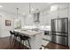 Charming kitchen featuring gray cabinets, a large center island, stainless steel appliances, and modern lighting at 420 Banbury Xing, Alpharetta, GA 30009
