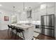 Modern kitchen with stainless steel appliances, an island with bar seating, and custom cabinetry at 420 Banbury Xing, Alpharetta, GA 30009