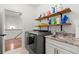 Practical laundry area with modern appliances, shelving, and sink at 420 Banbury Xing, Alpharetta, GA 30009