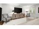 Living room featuring a large TV, neutral furniture, and stylish decor at 420 Banbury Xing, Alpharetta, GA 30009