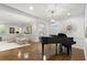 Living room with grand piano, modern lighting, and comfortable seating at 420 Banbury Xing, Alpharetta, GA 30009