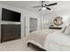 Bright main bedroom features a ceiling fan, wall-mounted TV, and elegant furnishings at 420 Banbury Xing, Alpharetta, GA 30009