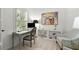 Bright office space with a desk, chair, and artwork creates an inspiring workspace at home at 420 Banbury Xing, Alpharetta, GA 30009