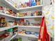 Walk-in pantry with custom shelving providing storage for a multitude of items at 420 Banbury Xing, Alpharetta, GA 30009