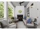 Relaxing porch with a fireplace, comfortable seating, ceiling fan, and view of the outdoors at 420 Banbury Xing, Alpharetta, GA 30009