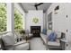 Inviting outdoor porch with a fireplace, comfortable seating, and serene views of lush greenery at 420 Banbury Xing, Alpharetta, GA 30009